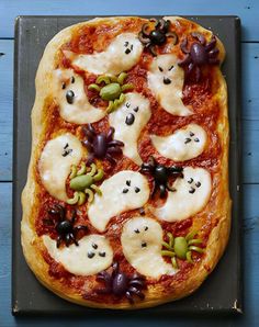 a pizza topped with lots of toppings on top of a pan