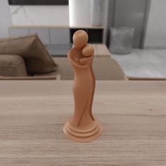 a small figurine sitting on top of a wooden table next to a couch