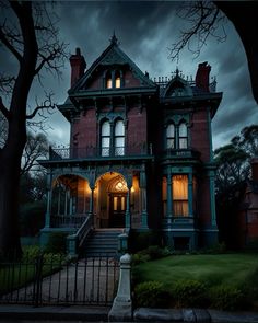 an old victorian style house lit up at night