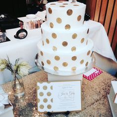 a wedding cake with gold polka dots on it