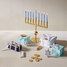 a hanukkah menorah, gift boxes and money on a table