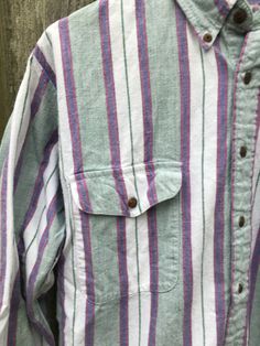 This is a great button up that isn't flashy or crazy, just simple and cool. It will look great with anything and is ready to go. It is in great condition and has no rips, holes, stains or smells. Measurements: Pit to pit: 22 1/4 inches Collar to bottom front: 23 3/4 inches Collar to bottom back: 26 inches Sleeve Length (from collar): 27 3/4 inches Size on tag: Medium 90s Cotton Tops With Button Closure, 90s Style Cotton Tops With Button Closure, Retro Button-up Shirt With Pockets, 90s Style Tops With Pockets For Fall, 90s Style Cotton Button-up Shirt, 90s Style Collared Shirt With Button Closure, 90s Style Cotton Shirt With Buttons, 90s Style Long Sleeve Shirt With Button Closure, Painters Pants