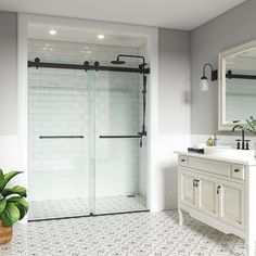 a bathroom with a sink, mirror and shower stall in the middle of the room