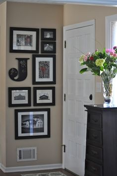 a vase filled with flowers sitting on top of a wooden table next to a white door