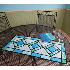 a table with some glasses on top of it and a place mat in the middle