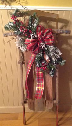 a wooden sled with a christmas wreath on it