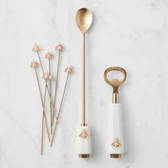 gold and white kitchen utensils on marble counter top