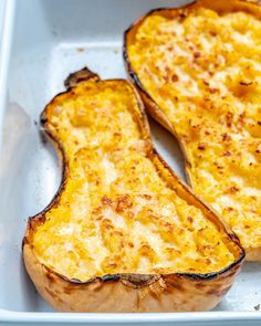 two baked potatoes sitting on top of a pan