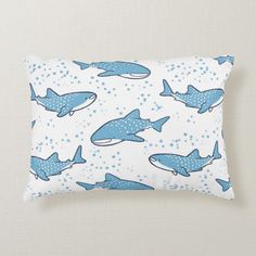 a blue and white pillow with sharks on it