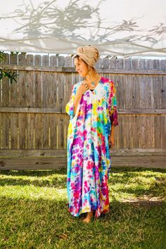 "Add a touch of unique style to your wardrobe with our Hand-Dyed Kaftan Dress! This stunning dress is made from 100% breathable and comfy rayon fabric, ensuring maximum comfort all day long. Using our unique method, each dress is carefully hand dyed, resulting in a one-of-a- kind masterpiece. The intricate patterns and vibrant colors make this dress a true work of art. The kaftan dress comes in a versatile one size fits most (M-3XL), making it extremely comfortable for a wide range of body types. With a bust measurement of up to 60\", you can feel confident that this dress will flatter your figure. The dress measures 55\" in length and 45\" in width, providing a loose and flowing fit that is both stylish and flattering. Featuring a trendy V-neck design and side slits, this slipover style d Hand Dyed Maxi Dress For Spring Vacation, Bohemian Tie Dye V-neck Kaftan, Bohemian Tie-dye V-neck Kaftan, Bohemian Hand Dyed Maxi Dress For Festivals, Flowy Hand Dyed Dress For Vacation, Hand Dyed Maxi Dress For Beach, Spring Tie Dye Maxi Kaftan, Hand Dyed Maxi Dress For Festival, Bohemian Hand-dyed Maxi Dress For Beach