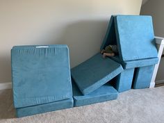 a child's bedroom with blue furniture and carpeted flooring in the corner