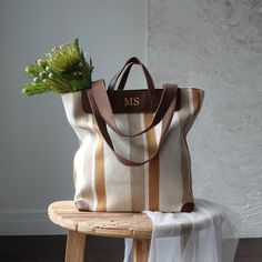 Striped Canvas Tote Bag with Monogram  Enhance your style with this elegant and versatile striped canvas tote bag. Featuring a timeless design with mustard and brown stripes, this tote bag is perfect for every occasion, from a casual day out to a beach trip. The monogram can be any name/initials you like,  adds a personalized touch, making it a unique addition to your accessory collection. Material: High-quality thick fabric with PU leather . Size: Please see picture. Everyday Bags With Striped Lining And Double Handle, Striped Canvas Shoulder Bag For Daily Use, Striped Large Capacity Shoulder Bag, Large Capacity Striped Rectangular Shoulder Bag, Brown Travel Bag With Striped Lining, Striped Rectangular Beach Bag, Canvas Bags With Striped Lining For Daily Use, Canvas Tote Bag With Striped Lining, Striped Double Handle Bags For Daily Use