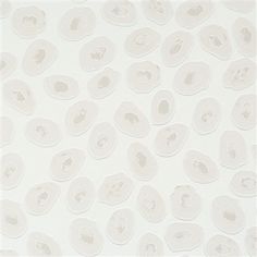 a white wall with lots of small circles on it's side and the bottom half of its face