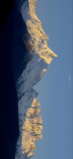 snow covered mountains are reflected in the water