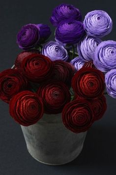 purple and red paper flowers in a bucket