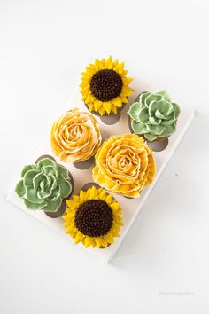 Vanilla cupcakes topped with buttercream succulents, sunflowers, and roses. Sunflowers And Succulents, Summer Cupcakes, Summer Flower Arrangements, Succulent Bouquet