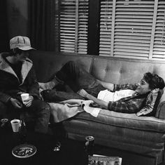 black and white photograph of two people sitting on a couch