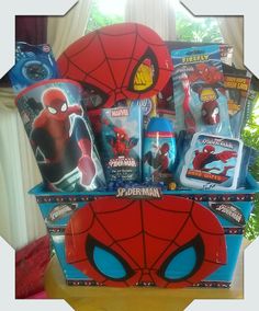 a spider man gift basket is shown in front of a window