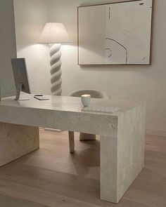 a desk with a computer on it in a room