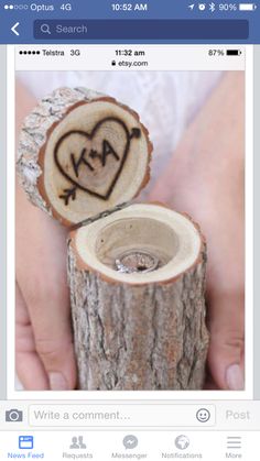 someone holding a piece of wood that has been carved into the shape of a heart