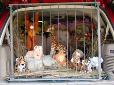 several stuffed animals are in a caged area