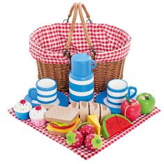 a picnic basket filled with food on top of a red and white checkered table cloth