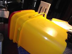 several yellow and red containers sitting on top of a table