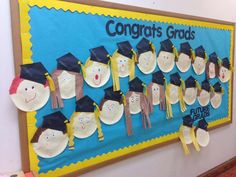 a bulletin board with paper plates and graduation caps on it that says congrats grads