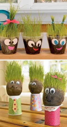 three potted plants with faces on them and one has grass growing out of it