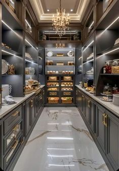 an elegant kitchen with marble floors and gray cabinets, along with chandelier hanging from the ceiling