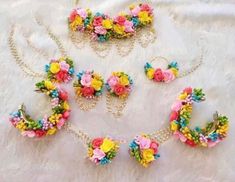 a necklace, bracelet and earrings with flowers on them