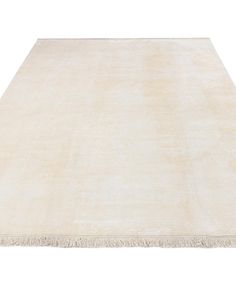 a white rug with fringes on the top and bottom side, in front of a white background