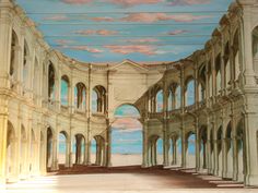 an empty room with many arches and windows on the ceiling is painted in pastel colors