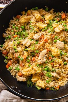 a pan filled with rice and vegetables on top of a table