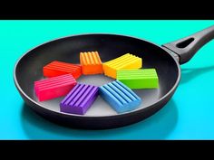 colorful popsicles in a frying pan on a blue background