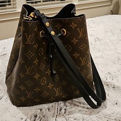 Lv Neo Noe Mng Noir Monogram Bucket Bag With Zip Pocket In Middle Of Bad, Adjustable Strap, Slight White Mark On Front Bottom Of Bag That Is Pictured, Otherwise Bag Is In Excellent Condition, Booklet Is Included, Gold Hardware, More Info Is In Pictures. This Is An Authentic Lv Bag. Front Bottoms, Leather Bucket Bag, Leather Bucket, White Mark, Lv Bag, Gold Hardware, Louis Vuitton Bag, Bucket Bag, Black And Brown