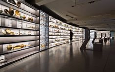 a room filled with lots of glass shelves covered in different types of gold and silver items