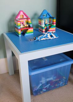 a table with legos on it and a plastic storage bin underneath the table top