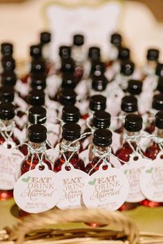 several bottles of red wine sitting on top of a table with tags attached to them