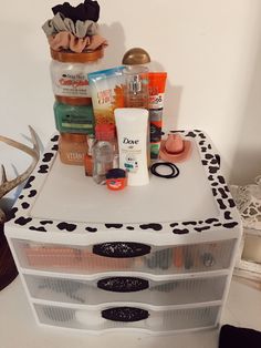 an assortment of personal care products on top of a white box with black and white designs