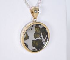 IMILAC PALLASITE METEORITE PENDANT - METEORITE JEWELRY - GOLD On Offer: Beautiful Imilac Pallasite Meteorite Pendant set in 14K Gold. Dimensions not including bail: Approximately 22.75mm x 3.40mm Dimensions including bail: Approximately 33.23mm x 6.34mm Includes an 18" gold chain. Value $450 The majestic Imilac meteorite is arguably one of the most beautiful pallasites ever discovered. The olivine crystals in these pallasite meteorites are among the most prized gemstones in the world. This piece Anniversary Pendant Jewelry With Natural Inclusions, Yellow Gold Jewelry With Natural Inclusions For Anniversary, Meteorite Jewelry, Meteorite Pendant, Gold Top, Bellows, Pendant Set, Pocket Watch, Gold Chain