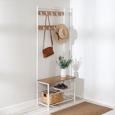 a white shelf with a hat and purse on it next to a brown rug in a room