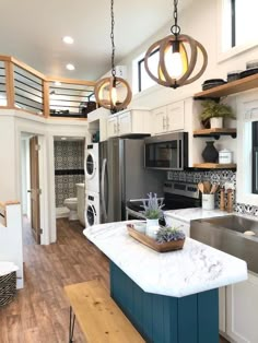 a kitchen with an island in the middle and lots of counter space next to it