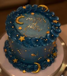 a blue and gold birthday cake with stars on it