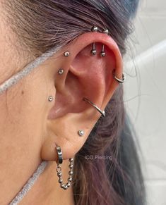 a close up of a person wearing ear piercings