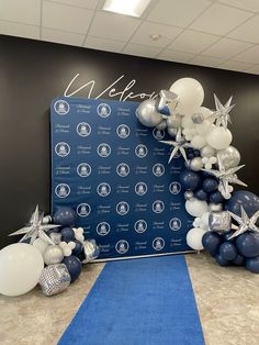 balloons and starfish are on display in front of a welcome sign at an event