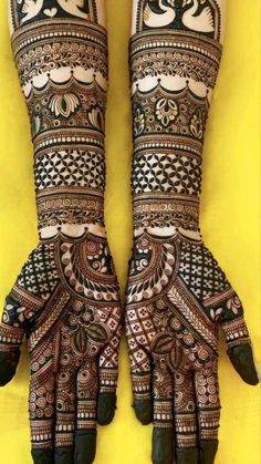 two hands with henna designs on them