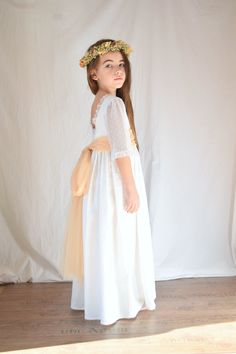 "Refined first communion dress or for little girls bridesmaids.  It's a dress made of medium weight linen, it is not lined as it is a full-bodied linen that does not show through.  This dress has a plunging back, the trim around the neck is embellished with soft valenciennes lace. It has 3/4 sleeves in plumetis cotton tulle (with polka dot motif) and valenciennes lace ruffles.  The dress is as long as it touches the shoes, it closes at the back with flower-shaped mother-of-pearl buttons. The wai Spring Princess Style First Communion Dress, White First Communion Dress For Spring, White Spring First Communion Dress, Spring First Communion Dress With Lace Trim, First Communion Dress, First Communion Dresses, White Flower Girl Dresses, Spring Girl, Baptism Dress