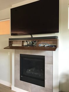 a flat screen tv mounted above a fireplace