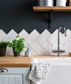 a white kitchen sink sitting under a window